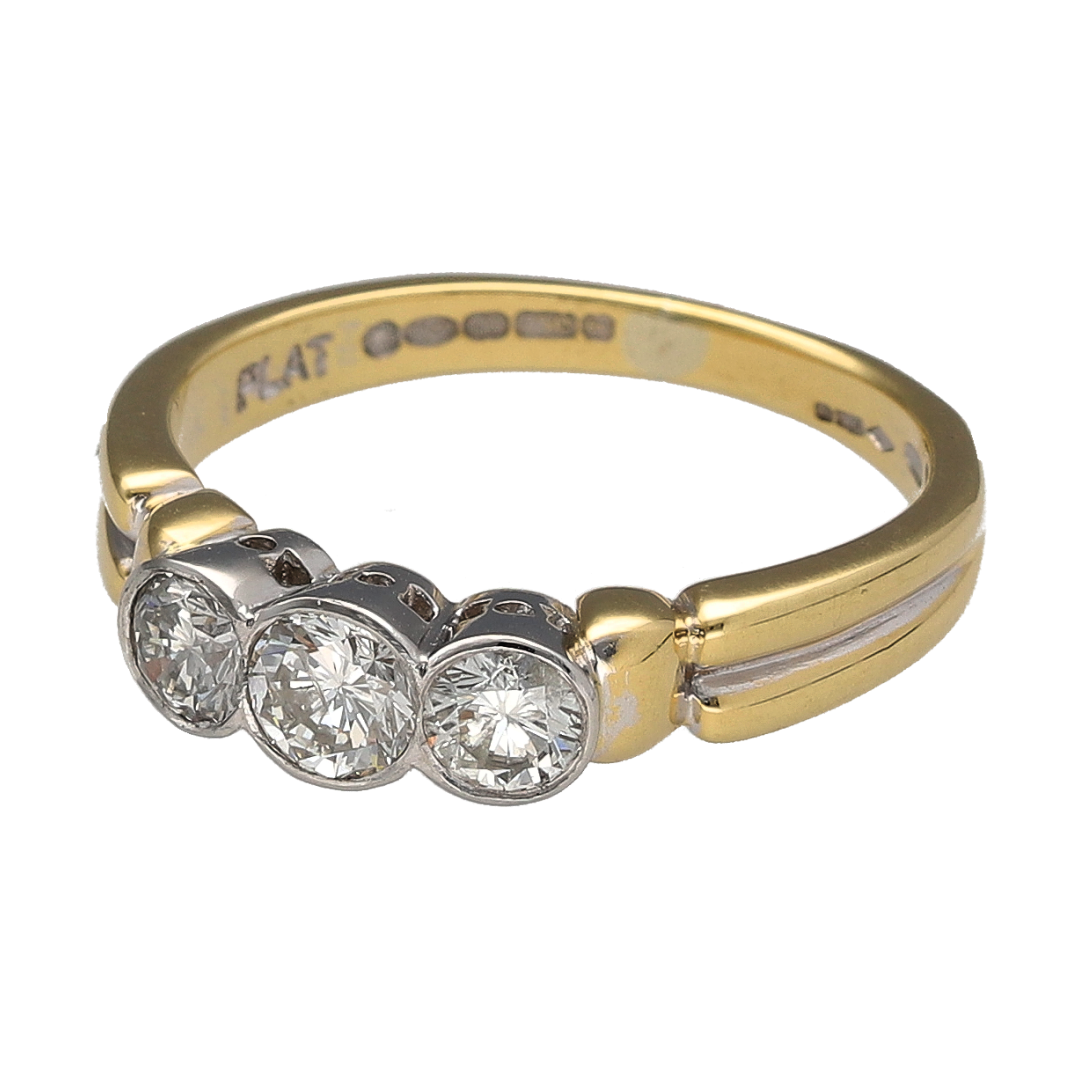 Add a timeless piece to your jewellery collection with this pre-owned 18ct yellow gold and platinum diamond trilogy ring, featuring three rubover set diamonds with a combined estimated weight of 0.70ct.

Design: The ring features a classic trilogy design, with three diamonds arranged across the front in smooth rubover settings, creating an elegant and traditional appearance.