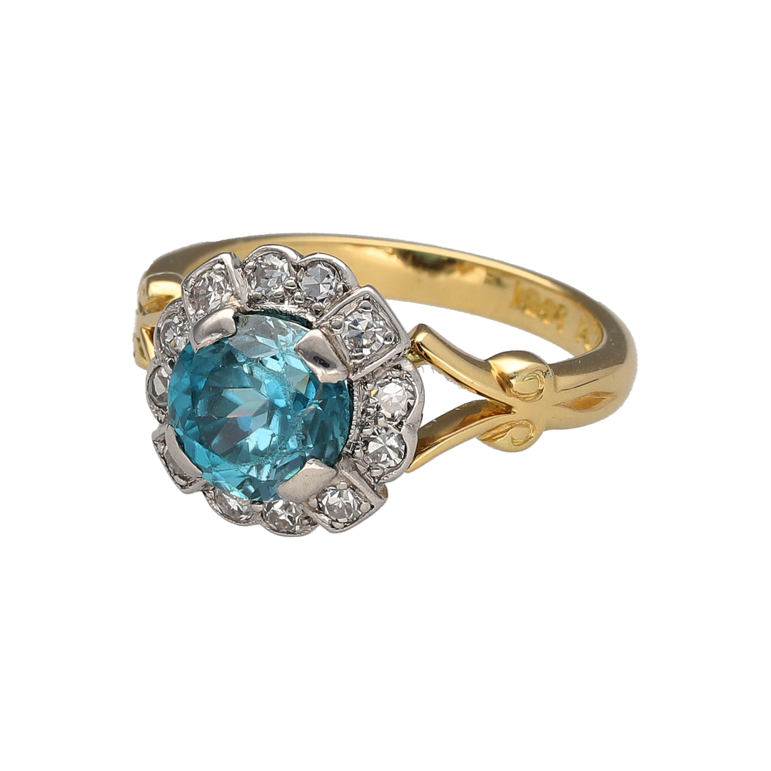 Add a distinctive vintage piece to your jewellery collection with this pre-owned 18ct yellow gold and platinum diamond and blue zircon cluster ring, featuring a vibrant blue zircon surrounded by diamond detailing.

Design: The ring features a traditional vintage cluster design, with a central round blue zircon complemented by diamonds for an elegant and eye-catching appearance.
Material: Made from 18ct yellow gold and platinum, offering a classic combination of precious metals.