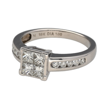 Load image into Gallery viewer, Preowned 18ct White Gold &amp; Diamond Illusion Set Princess Cut Solitaire Ring in size P with the weight 5.60 grams. The front of the ring is 8mm high and the ring is made up of four smaller princess cut diamonds set together to create the illusion of a bigger stone
