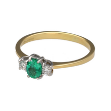 Load image into Gallery viewer, Preowned 18ct Yellow and White Gold Diamond &amp; Emerald Set Trilogy Ring in size R with the weight 2.80 grams. The emerald stone is approximately 6mm by 5mm and there is approximately 12pt of diamond content in total
