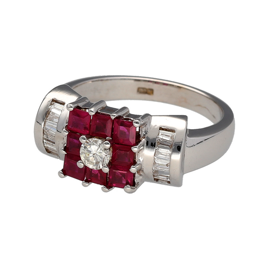Preowned 18ct White Gold Diamond & Ruby Set Dress Ring in size Q with the weight 8.90 grams. The front of the ring is 9mm high and the ruby stones are each approximately 2mm by 2mm