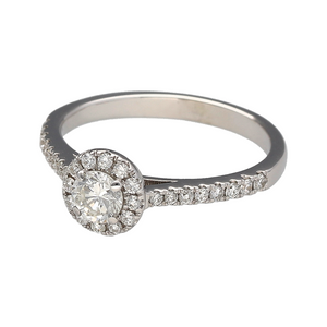 Add a touch of timeless elegance to your jewellery collection with this pre-owned 18ct white gold & diamond set halo ring, featuring:

Design: A stunning halo ring, with a central diamond surrounded by a halo of smaller diamonds for enhanced brilliance.
Material: 18-carat white gold, offering a sleek and luxurious finish.
Gemstones: Features a centre diamond of approximately 0.25ct, with additional diamond-set shoulders for extra sparkle.
Size & Weight: Designed in size K, with a well-balanced weight of 2.5