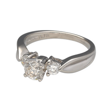 Load image into Gallery viewer, Add a timeless and sophisticated piece to your jewellery collection with this pre-owned platinum &amp; diamond set trilogy ring, featuring:

Design: A classic trilogy ring, symbolising the past, present, and future with its stunning three-diamond setting.
Material: Platinum, known for its durability and luxurious appeal.
Gemstones: Features a brilliant-cut centre diamond of approximately 0.46ct, complemented by two smaller brilliant-cut diamonds of approximately 0.11ct each
