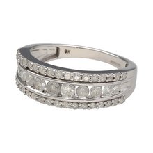 Load image into Gallery viewer, Add radiant sparkle to your jewellery collection with this pre-owned 9ct white gold diamond set band ring, featuring:

Design: A wide band design with three dazzling rows of brilliant-cut diamonds, creating a bold yet elegant look with maximum sparkle.
Material: 9-carat white gold, polished to a bright finish that enhances the brilliance of the diamonds.
Gemstone Detail: Set with three rows of brilliant-cut diamonds, offering eye-catching light reflection and refined elegance.


