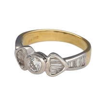 Load image into Gallery viewer, Celebrate love past, present, and future with this pre-owned 18ct yellow and white gold diamond trilogy ring, featuring:

Design: A sophisticated trilogy arrangement with a brilliant-cut central diamond, framed by heart-shaped settings crafted from baguette-cut diamonds on each side. Additional baguette diamonds on the shoulders enhance the elegant and romantic design.

