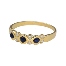 Load image into Gallery viewer, Add rich colour and refined sparkle to your jewellery collection with this pre-owned 18ct yellow gold diamond and sapphire band ring, featuring:

Design: A beautifully balanced band set with three round cabochon sapphires, accented by eight brilliant-cut diamonds arranged in an elegant pattern above, below, and between the stones.
Material: 18-carat yellow gold, offering a luxurious, polished finish that enhances the depth and colour of the gemstones.

