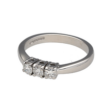 Load image into Gallery viewer, Celebrate the beauty of enduring love with this pre-owned 18ct white gold diamond set trilogy ring, symbolising the past, present, and future with timeless sparkle and graceful design, featuring:

Design: A classic trilogy style showcasing three brilliant diamonds in a balanced arrangement, representing life’s most meaningful moments.
Material: Made from 18-carat white gold, the polished finish enhances the brightness of the setting and beautifully complements the brilliance of the diamonds.
