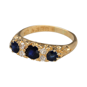 Embrace classic elegance with this pre-owned 18ct yellow gold diamond and sapphire set vintage ring, showcasing rich colour and traditional design, perfect for those who appreciate timeless style with a heritage feel, featuring:

Design: A beautifully balanced vintage-style ring with a trilogy of round sapphires, accented by delicate diamonds that add subtle brilliance and depth to the design.
Material: Made from 18-carat yellow gold, the polished finish enhances the warmth of the gold and the deep