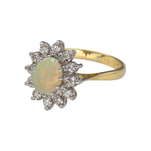 Load image into Gallery viewer, Bring radiant colour and timeless elegance to your collection with this pre-owned 18ct yellow gold diamond and opal set cluster ring, featuring a vibrant centre stone surrounded by sparkling brilliance—perfect for special occasions or refined everyday wear.

Design: The ring features a captivating 8mm by 6mm oval opal at the centre, surrounded by a halo of shimmering diamonds in a classic cluster arrangement for maximum impact and elegance.


