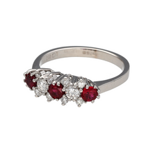 Load image into Gallery viewer, Bring rich colour and elegant sparkle to your collection with this pre-owned 18ct white gold diamond and ruby set cluster style band ring, blending classic design with vibrant detail—perfect for special occasions or timeless everyday wear.

Design: The ring features three vivid round ruby stones, each 3.5mm in diameter, interspaced with ten brilliant-cut diamonds in a cluster style setting for a beautifully balanced and luxurious look.
