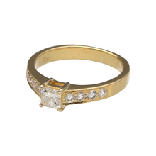Load image into Gallery viewer, Bring timeless brilliance and refined elegance to your collection with this pre-owned 18ct yellow gold diamond set solitaire ring, combining classic design with sparkling detail—perfect for special occasions or a meaningful gift.

Design: The ring features a princess-cut centre diamond of approximately 0.39ct, flanked by four brilliant-cut diamonds on each shoulder, totalling approximately 0.24ct, for added shimmer and sophistication.
