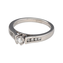 Load image into Gallery viewer, Bring classic sophistication and timeless sparkle to your collection with this pre-owned 18ct white gold diamond set solitaire ring, featuring a refined design with elegant detail—perfect for engagements or meaningful celebrations.

Design: The ring showcases a central brilliant-cut diamond of approximately 0.25ct, complemented by additional diamonds set along the shoulders for added sparkle and graceful symmetry.

