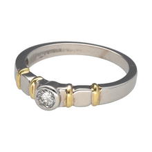Load image into Gallery viewer, Bring modern elegance and refined contrast to your collection with this pre-owned 18ct white gold solitaire ring, featuring a rubover-set diamond and distinctive yellow gold shoulder accents—perfect for a sleek and sophisticated statement.

Design: The ring showcases a brilliant-cut diamond of approximately 0.25ct, securely held in a rubover setting that offers a smooth, contemporary profile. The diamond has an approximate clarity of VS2, ensuring impressive sparkle and clarity.
