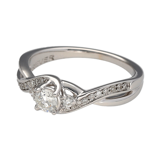 Bring refined brilliance and graceful movement to your collection with this pre-owned 18ct white gold diamond set twist solitaire ring—perfect for elegant sparkle with a modern twist.

Design: The ring features a central brilliant-cut diamond flanked by two smaller brilliant-cut diamonds and complemented by diamond-set shoulders, with a total diamond weight of approximately 0.40ct.
