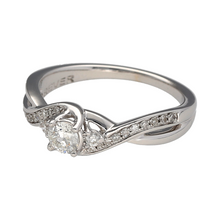 Load image into Gallery viewer, Bring refined brilliance and graceful movement to your collection with this pre-owned 18ct white gold diamond set twist solitaire ring—perfect for elegant sparkle with a modern twist.

Design: The ring features a central brilliant-cut diamond flanked by two smaller brilliant-cut diamonds and complemented by diamond-set shoulders, with a total diamond weight of approximately 0.40ct.

