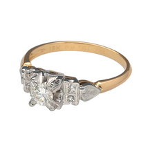 Load image into Gallery viewer, Bring timeless brilliance and elegant contrast to your collection with this pre-owned 18ct yellow gold and diamond solitaire ring—a refined classic with a touch of unique charm.

Design: This ring features a brilliant-cut diamond of approximately 0.25ct, secured in a decorative white gold setting that enhances its sparkle and presence.
Material: Made from 18-carat yellow gold with a white gold setting, the two-tone design adds depth and highlights the central stone.

