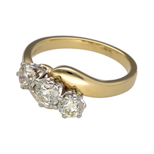 Load image into Gallery viewer, Celebrate past, present, and future with this pre-owned 18ct yellow gold trilogy twist ring, featuring brilliant cut diamonds in an elegant, flowing design.

Design: The ring showcases three brilliant cut diamonds with a total estimated diamond weight of approximately 1ct, arranged in a graceful twist that symbolises connection and continuity.
Material: Made from 18-carat yellow gold, the warm, polished band enhances the sparkle and clarity of the diamonds for a luxurious finish.

