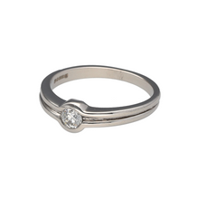 Load image into Gallery viewer, Bring modern elegance and refined sparkle to your collection with this pre-owned 18ct white gold diamond solitaire ring—a timeless piece with understated brilliance.

Design: The ring features a single brilliant-cut diamond of approximately 0.15ct, secured in a rubover setting for a sleek and contemporary look.
Material: Made from 18-carat white gold, the polished finish enhances the clean design and the natural sparkle of the diamond.

