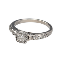 Load image into Gallery viewer, Bring sparkle and sophistication to your collection with this pre-owned 18ct white gold princess cut halo diamond ring, a timeless style full of brilliance.

Design: The ring features a princess cut diamond at the centre, framed by a halo of diamonds and further enhanced with diamond-set shoulders for extra radiance.
Material: Made in 18-carat white gold, the polished finish offers a bright, modern backdrop that enhances the diamonds’ fire and sparkle.
