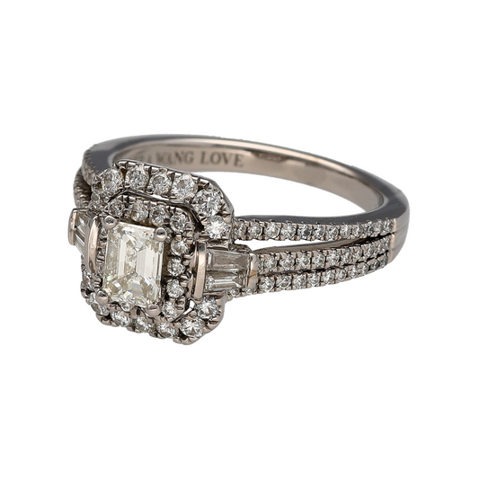 Bring exceptional luxury and iconic designer elegance to your jewellery collection with this pre-owned 18ct white gold diamond set Vera Wang cluster halo ring, a breathtaking statement piece with exquisite detail.

Design: The ring features a striking emerald-cut diamond at the centre, surrounded by a halo of baguette and brilliant-cut diamonds, creating a sophisticated and radiant cluster effect. The band is split into three diamond-set rows, adding depth, brilliance, and a bold architectural presence.