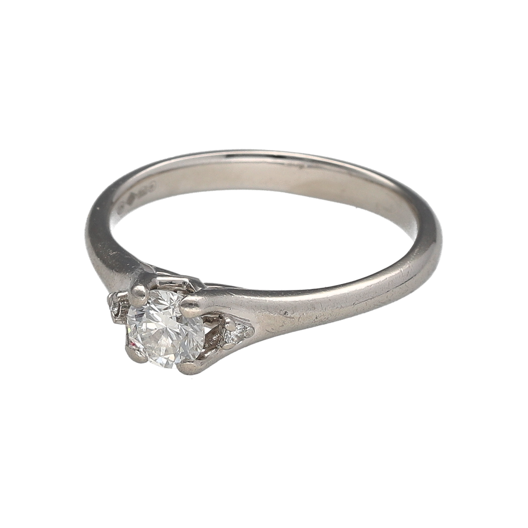 Add timeless elegance and refined sparkle to your jewellery collection with this pre-owned platinum diamond solitaire ring, offering classic design with subtle added brilliance.

Design: This solitaire ring features a central diamond measuring approximately 0.44ct, flanked by a small diamond on either side to enhance sparkle while maintaining a balanced and elegant look. The diamonds have an estimated clarity of SI1.
