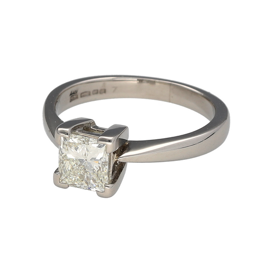 Make a powerful statement with this pre-owned platinum and diamond set solitaire ring—an exceptional piece designed to showcase bold brilliance and timeless elegance.

Design: The ring features a striking princess cut diamond weighing approximately 1ct, offering sharp, clean facets and impressive sparkle. The classic solitaire setting allows the square-cut stone to take centre stage, creating a modern yet enduring silhouette. 