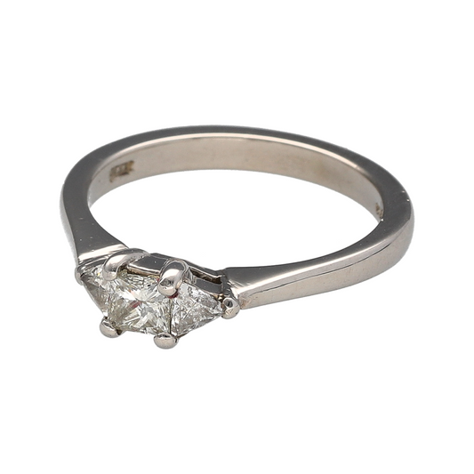 Celebrate timeless elegance with this pre-owned platinum diamond trilogy ring, featuring a striking combination of princess and trillion cut diamonds—an exquisite choice for an engagement ring or meaningful gift.

Design: The ring showcases a princess cut diamond at the centre, flanked by two beautifully matched trillion cut diamonds. With approximately 0.53ct total diamond content, the trilogy arrangement creates a balanced, eye-catching silhouette while symbolising past, present and future.