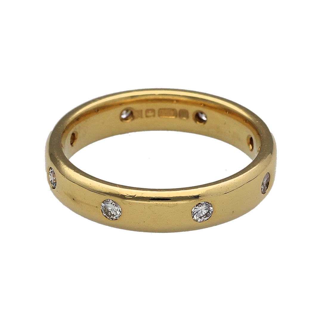 Add a touch of classic elegance to your jewellery collection with this pre-owned 18ct yellow gold diamond set band ring, combining timeless design with subtle sparkle—perfect for everyday wear or special occasions.

Design: The ring features a classic band design with evenly spaced diamonds across the front, creating a balanced and refined look.
Material: Made from 18-carat yellow gold, it has a polished finish that enhances its rich, warm tone and highlights the diamonds.