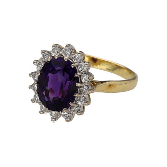 Add a touch of rich colour and elegant sparkle to your jewellery collection with this pre-owned 18ct yellow gold diamond and amethyst set cluster ring—an eye-catching piece perfect for special occasions or everyday luxury.

Design: This ring features a striking oval amethyst at the centre, measuring approximately 10mm by 8mm, surrounded by brilliant-cut diamonds that create a radiant and balanced cluster design.