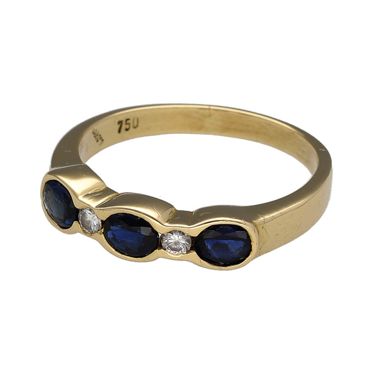 Add rich colour and refined sparkle to your collection with this pre-owned 18ct yellow gold diamond and sapphire set trilogy ring—an elegant piece with timeless appeal.

Design: The ring features three oval sapphire stones, each measuring approximately 4mm by 3mm, complemented by diamonds set between each sapphire at approximately 0.10ct each, creating a beautifully balanced and eye-catching arrangement.