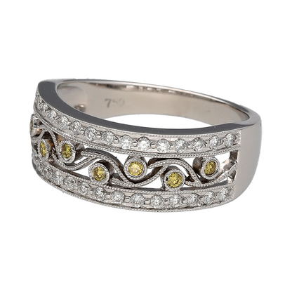 Add striking contrast and intricate detail to your collection with this pre-owned 18ct white gold white and yellow diamond set open band ring—an eye-catching piece with luxurious appeal.

Design: The ring features an 8mm wide open band front, crafted in a delicate filigree style pattern and set with a mix of white and yellow round diamonds, creating a beautifully detailed and textured look.