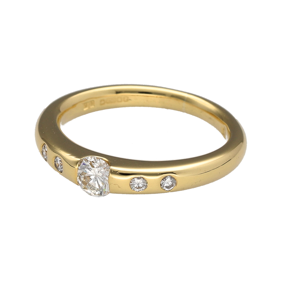 Add timeless elegance and luxurious sparkle to your jewellery collection with this pre-owned 18ct yellow gold diamond set solitaire ring, featuring a classic brilliant cut centre diamond with elegant shoulder detailing—perfect for engagements, anniversaries, or sophisticated everyday wear.

Design: The ring showcases a sparkling brilliant cut centre diamond of approximately 0.25ct, complemented by two additional diamonds set into each shoulder for enhanced brilliance and refined elegance.