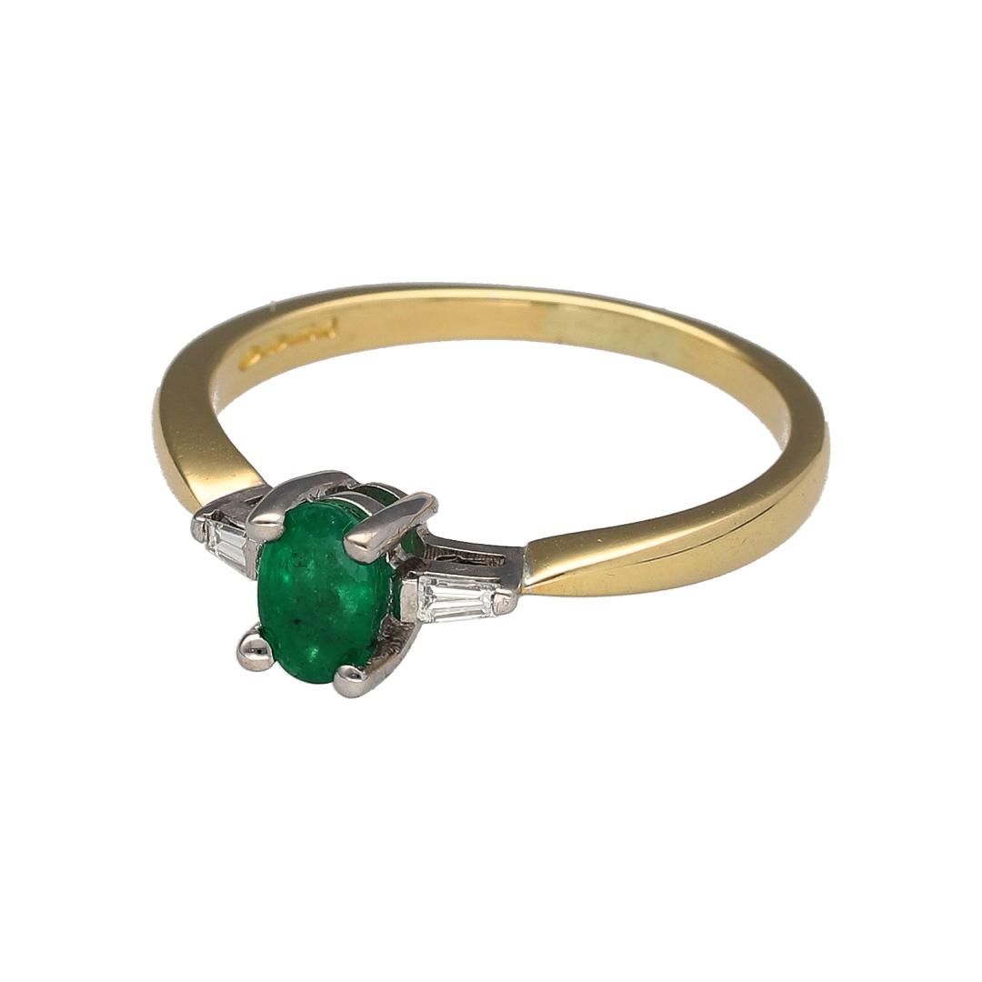 Bring timeless elegance and vibrant colour to your jewellery collection with this pre-owned 18ct yellow gold diamond and emerald ring. Featuring a beautiful emerald centre stone accented by baguette-cut diamonds, this sophisticated ring offers a classic design that is perfect for both special occasions and everyday luxury.

Design: The ring showcases a stunning 6mm by 4mm oval-cut emerald at its centre, displaying the rich green colour that has made emerald one of the most sought-after precious gemstones.