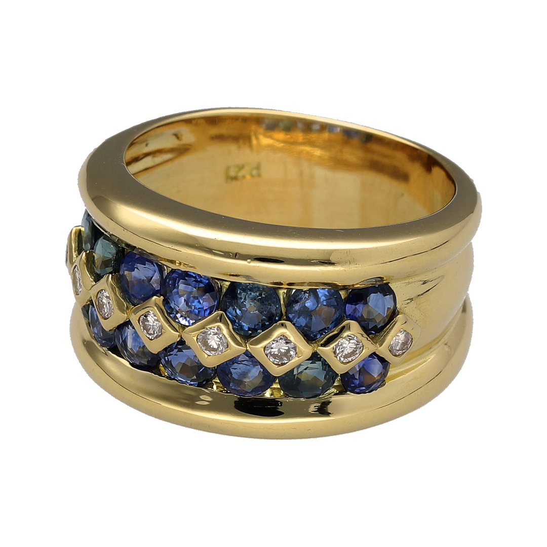 Make a bold statement with this pre-owned 18ct yellow gold diamond and sapphire wide band ring. Featuring a luxurious multi-row design with rich blue sapphires and sparkling diamonds, this substantial ring combines timeless elegance with exceptional presence.

Design: The ring showcases an impressive 13mm wide front, featuring two rows of vibrant blue sapphires with a row of sparkling diamonds running through the centre.