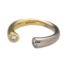 Load image into Gallery viewer, Add modern elegance to your collection with this pre-owned 18ct yellow and white gold torque band ring, finished with sparkling diamonds for a refined statement.

Design: The ring features a contemporary torque band style, accented with a brilliant-cut diamond at each end for balance and sophistication.
Material: Made in 18-carat yellow and white gold, the polished finish enhances the contrast of tones while highlighting the brilliance of the diamonds.
