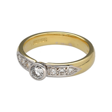 Load image into Gallery viewer, Celebrate timeless beauty with this pre-owned 18ct yellow gold diamond solitaire ring, enhanced with diamond-set shoulders for added brilliance and elegance.

Design: The ring features a central brilliant-cut diamond of approximately 0.46ct, complemented by sparkling diamonds along the shoulders for extra radiance.
Material: Made in 18-carat yellow gold, the polished finish provides a warm glow that enhances the fire and brilliance of the diamonds.
