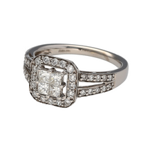 Load image into Gallery viewer, Add refined sparkle to your collection with this pre-owned 9ct white gold princess cut cluster solitaire ring, designed with brilliance and elegance for a timeless statement.

Design: The ring features four princess cut diamonds at the centre, set together to create the look of a larger stone, framed by a halo of diamonds and further enhanced with diamond-set split shoulders.
Material: Made in 9-carat white gold, the polished finish complements the bright sparkle of the diamonds with a sleek, modern tone.
