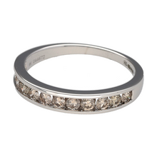 Load image into Gallery viewer, Add refined brilliance and modern elegance to your collection with this pre-owned 9ct white gold diamond set band ring—perfect for timeless sparkle with a contemporary edge.

Design: The front of the band measures approximately 3.5mm wide and features a row of channel-set diamonds, offering a clean and sophisticated look.
Material: Made from 9-carat white gold, the sleek polished finish enhances the brilliance of the diamonds with a bright, modern glow.

