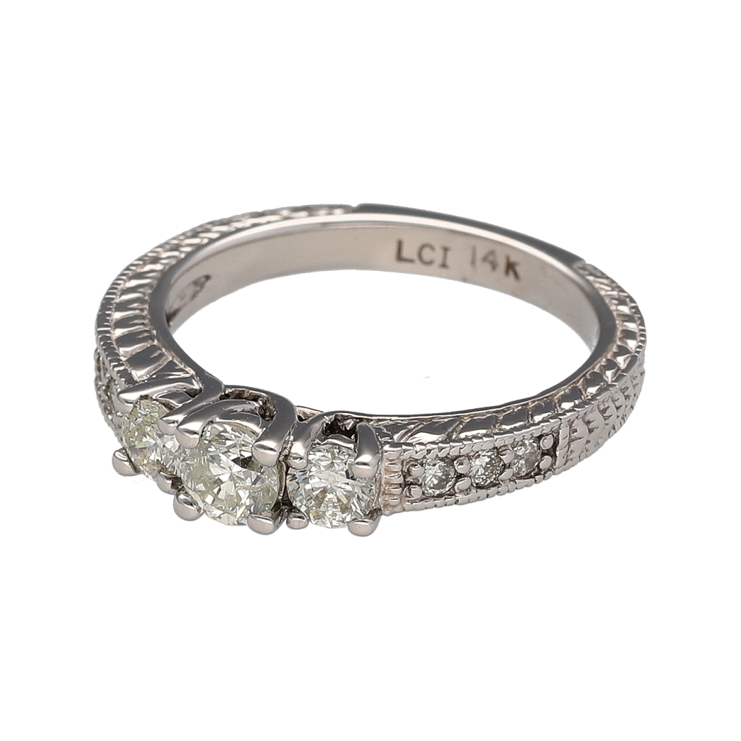 Add timeless brilliance to your jewellery collection with this pre-owned 14ct white gold diamond trilogy ring, featuring a classic three-stone design with diamond-set shoulders and beautifully patterned detailing—perfect for special occasions or everyday luxury.

Design: The ring showcases a stunning trilogy of brilliant-cut diamonds, complemented by additional diamond-set shoulders to create exceptional sparkle.