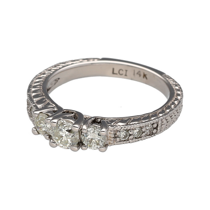 Add timeless brilliance to your jewellery collection with this pre-owned 14ct white gold diamond trilogy ring, featuring a classic three-stone design with diamond-set shoulders and beautifully patterned detailing—perfect for special occasions or everyday luxury.

Design: The ring showcases a stunning trilogy of brilliant-cut diamonds, complemented by additional diamond-set shoulders to create exceptional sparkle.