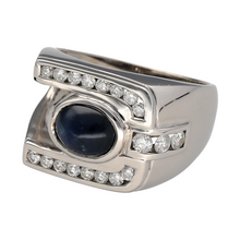 Load image into Gallery viewer, Add bold sophistication and striking colour to your collection with this pre-owned 9ct white gold diamond and sapphire set dress signet style ring—a powerful statement piece that combines classic elegance with contemporary style, perfect for special occasions or standout everyday wear.

Design: This signet style ring features a prominent front measuring 15mm high, showcasing an oval sapphire at the centre, approximately 8mm by 6mm, framed by sparkling diamonds for an eye-catching, luxurious finish.

