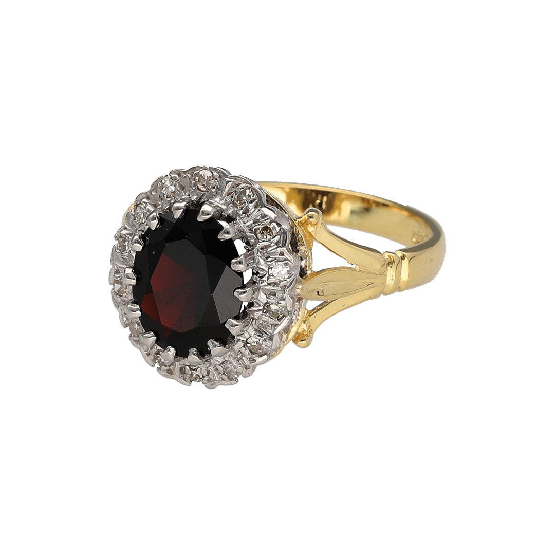 Add vintage-inspired elegance and rich colour to your collection with this pre-owned 18ct yellow and white gold diamond and garnet cluster ring, offering timeless beauty and luxurious detail—perfect for special occasions or refined everyday wear.

Design: The ring features a striking 9mm by 7mm oval-cut garnet at the centre, surrounded by a halo of sparkling diamonds that enhance the deep red tones of the gemstone.
