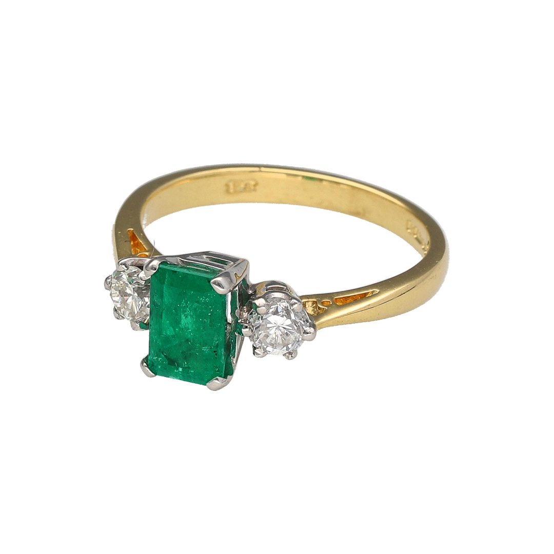 Add a touch of classic elegance and rich colour to your collection with this pre-owned 18ct yellow gold diamond and emerald trilogy ring, symbolising the past, present, and future—perfect for meaningful occasions or timeless everyday luxury.

Design: The ring features a 7mm by 5mm rectangular emerald at the centre, flanked by two brilliant-cut diamonds of approximately 0.20ct each, creating a refined and balanced three-stone arrangement.