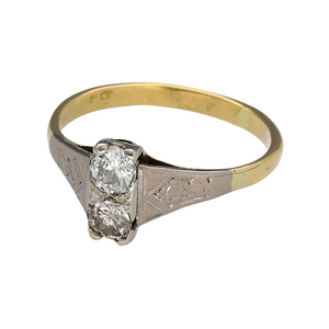 Preowned 18ct Yellow Gold & Platinum Diamond Set Antique Style Ring in size M with the weight 2.80 grams. This ring has an Art Deco style and contains two Diamonds which are approximately 25pt each and are brilliant cut. There is a total of 50pt Diamonds set in this ring and the front of the ring is approximately 8mm high