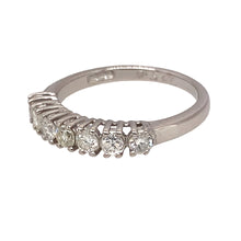 Load image into Gallery viewer, Preowned 18ct White Gold &amp; Diamond Set Seven Stone Band Ring in size K with the weight 2.60 grams. There is approximately 50pt of Diamond content set in the 3mm band made up of seven brilliant cut Diamonds. The Diamonds are approximate clarity i1 - i2 and colour K - M
