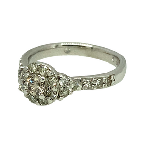 Preowned Platinum & Diamond Set Halo Ring with Diamond set shoulders in size H with the weight 4.20 grams. There is approximately 40pt of Diamonds and the center stone is approximately 10pt. The Diamonds are approximately clarity Si1 and colour M - N