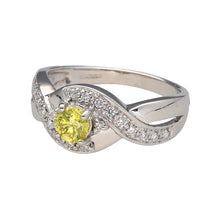 Load image into Gallery viewer, Preowned 18ct White Gold &amp; Diamond Twist Over Set Ring in size N with the weight 5.40 grams. The center Diamond is yellow and is approximately 36pt - 40pt. The yellow Diamond is surrounded by smaller white Diamonds which go onto the shoulders
