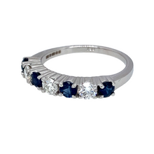 Load image into Gallery viewer, Preowned 18ct White Gold Diamond &amp; Sapphire Eternity Style Band Ring in size N with the weight 3.60 grams. There is approximately 18pt to 20pt of Diamond content in total set in three brilliant cut Diamonds. The Diamonds are all approximate clarity Si1 and colour J - K. There are three round cut sapphires at approximate size 3mm diameter each
