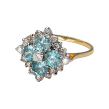 Load image into Gallery viewer, Preowned 18ct Yellow and White Gold Diamond &amp; Aquamarine Set Cluster Dress Ring in size S with the weight 6 grams. The ring is made up of four aquamarine stones approximately 5mm diameter each, a center Diamond which is approximately 10pt and sixteen surrounding Diamond at approximately 40pt in total. There is an approximate Diamond content total of 50pt and the front of the ring is 18mm
