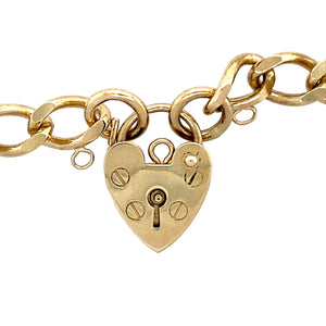 Preowned 9ct Yellow Gold 7" Charm Bracelet with a heart padlock. The bracelet has the weight 13.60 grams and the link width 7mm 